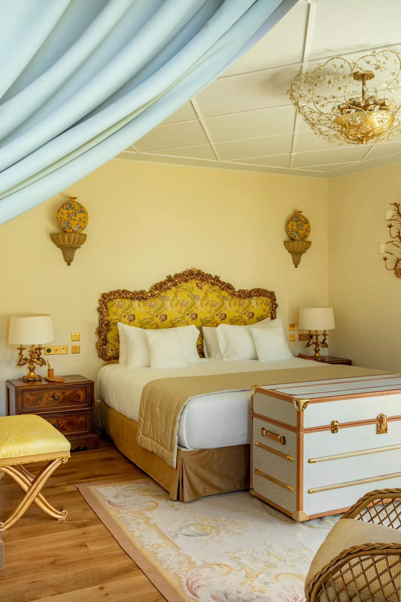 Schlafzimmer mit Baldachin und vergoldetem Kopfteil