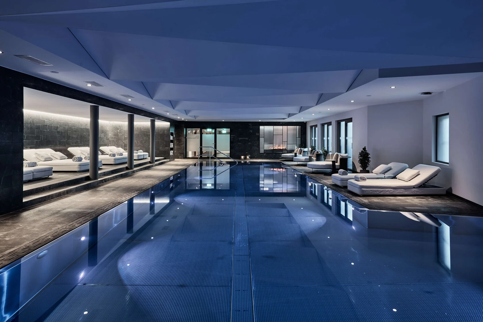 Innenpool des Spa mit Liegen und indirektem Licht