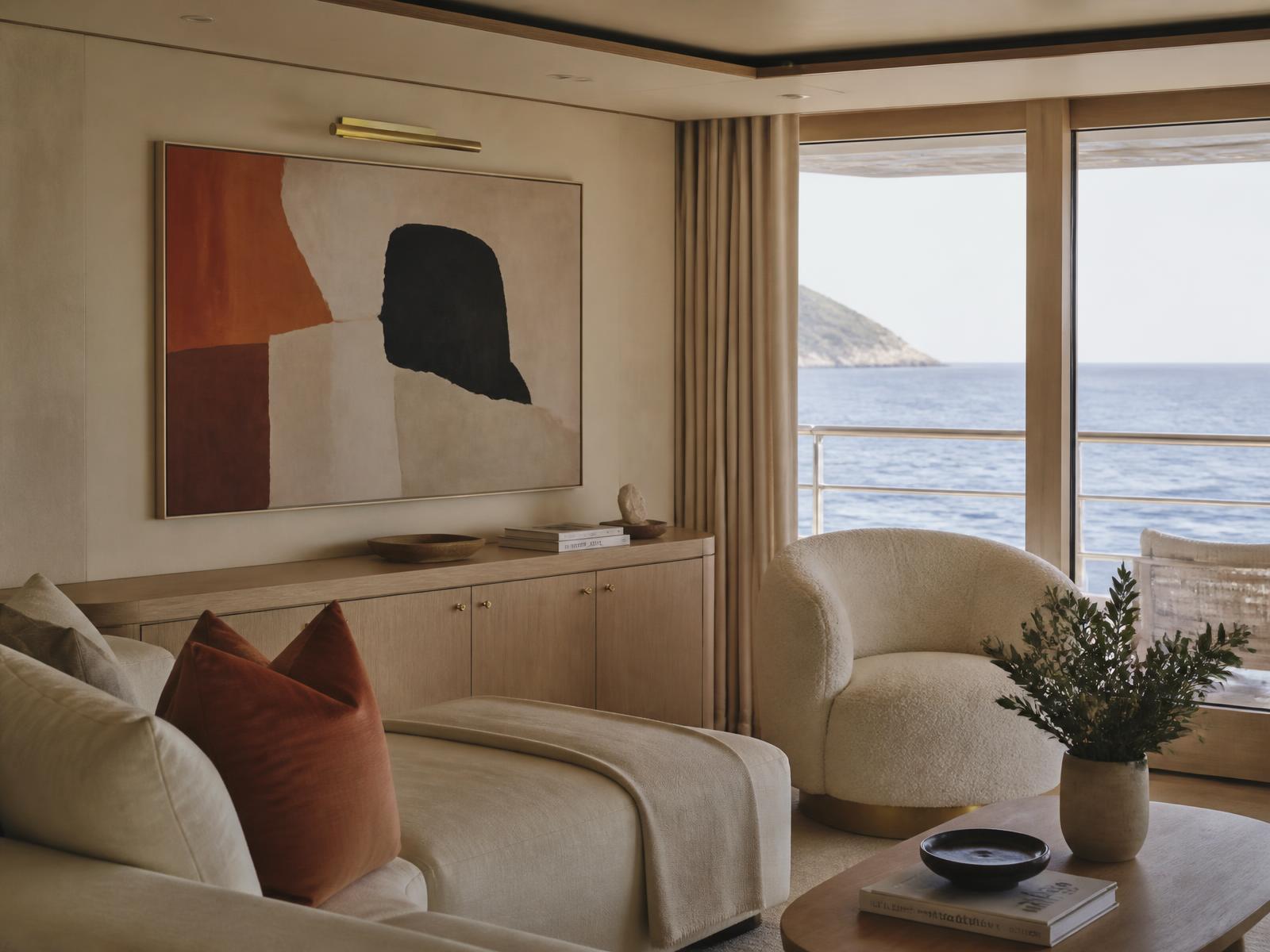 Intimate yacht lounge with cream linen sofas, pale oak joinery, a large abstract painting on a lime-plaster wall and glass onto the Mediterranean