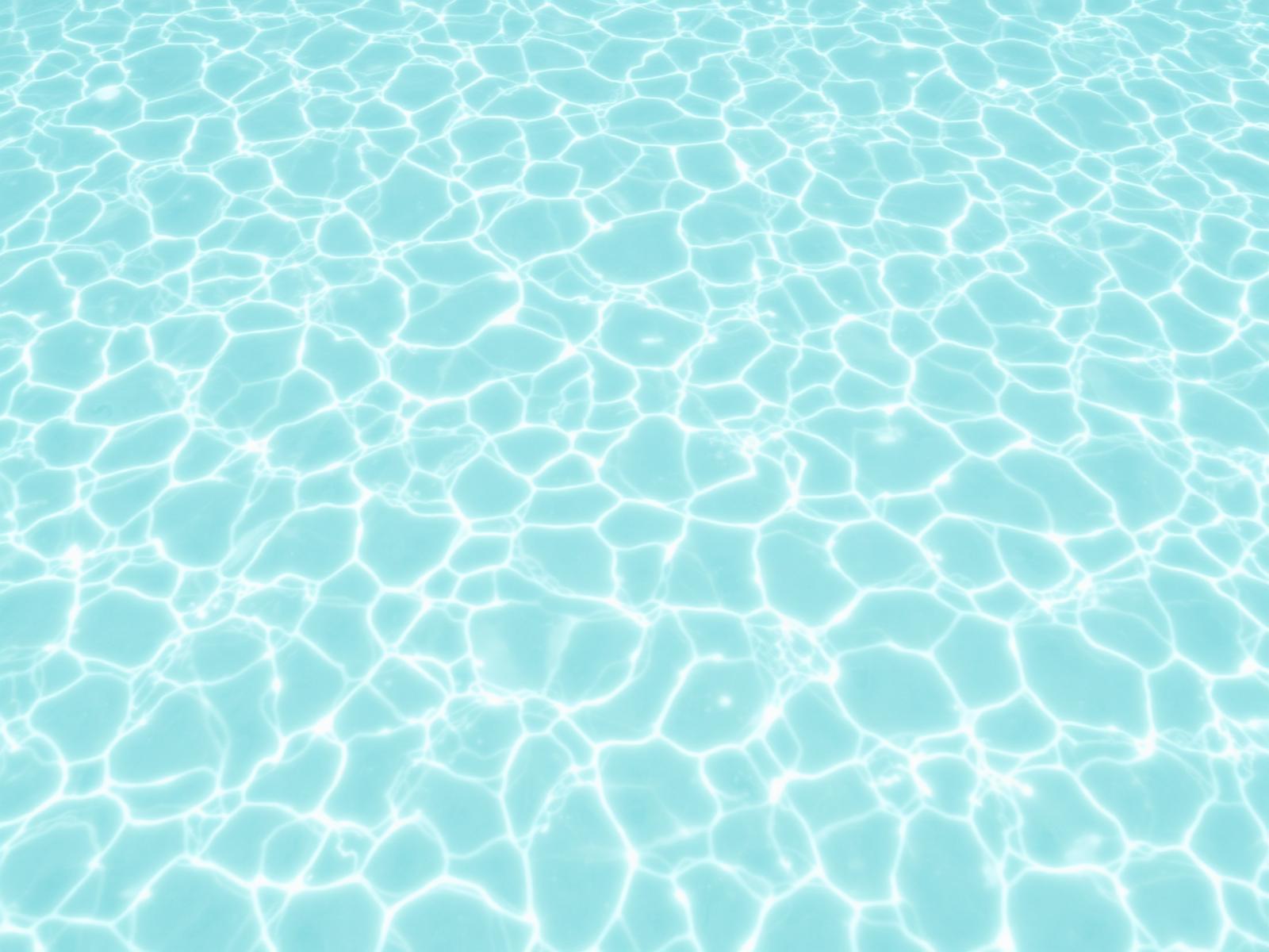 Clear turquoise shallow Caribbean water rippling with light over pale sand