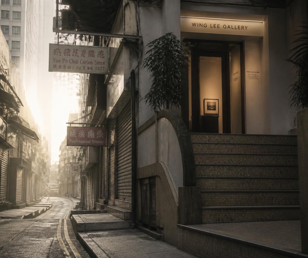 Narrow Hong Kong street in early morning light with old shophouse shutters, hanging signs and a small gallery entrance