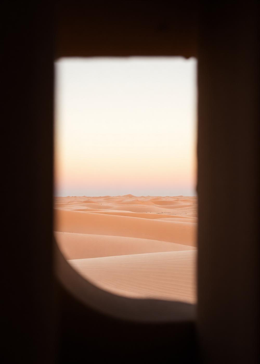 Desert horizon at first light seen through a narrow concrete aperture